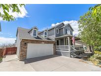 Charming two-story home with a two car garage, covered porch, and landscaped yard at 821 S 34Th Ave, Brighton, CO 80601