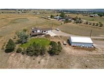 Sprawling property with a charming home, large workshop, and picturesque views of rolling hills at 1143 Belgian Trl, Elizabeth, CO 80107