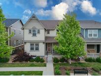 Charming two-story home with a landscaped front yard and inviting front porch and mature shade tree at 540 E Fremont Pl, Centennial, CO 80122