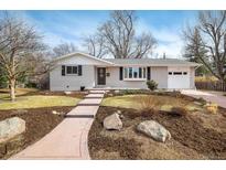 Charming single-story home featuring a brick facade, well-maintained landscaping, and an attached garage at 350 Auburn St, Boulder, CO 80305