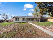 Charming single-story home with a well-maintained front yard and a welcoming pathway at 10280 W 8Th Ave, Lakewood, CO 80215