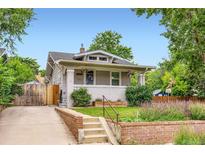 Charming two-story home with a landscaped front yard and a quaint covered porch at 4057 Bryant St, Denver, CO 80211