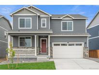 Beautiful two-story home featuring a charming front porch and a two-car garage at 14239 Beebalm Ave, Parker, CO 80134