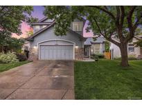 Charming two-story home boasts a well-manicured lawn and attached two car garage at 11263 Vrain Dr, Westminster, CO 80031
