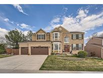 Charming two-story brick home with a manicured front yard and an attached two-car garage at 11710 Crow Hill Dr, Parker, CO 80134