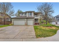 Charming two-story home features a well-maintained front yard and three-car garage at 8807 Tuscany Ln, Highlands Ranch, CO 80130