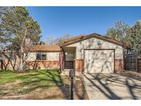 Charming single-Gathering home featuring a brick and siding exterior with an attached garage at 2210 S Oakland Way, Aurora, CO 80014