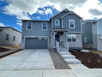 Charming two-story home featuring a modern exterior with a two-car garage and stone accents at 22016 E 39Th Pl, Aurora, CO 80019