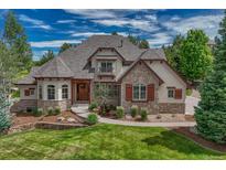 Charming two-story home featuring stone accents, a landscaped yard, and a welcoming entrance at 9121 Sunshine Meadow Pl, Parker, CO 80134