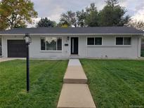 Charming single-story home with lush green lawn and inviting walkway, enhancing its curb appeal at 35 Everett St, Lakewood, CO 80226