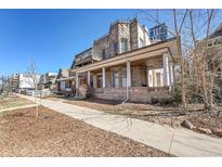 Charming stone home featuring a balcony and a covered front porch with classic architectural details at 54 S Emerson St # 4, Denver, CO 80209