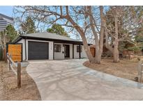 Charming single-story home with a well-manicured front yard and a private driveway at 1130 S Harrison St, Denver, CO 80210