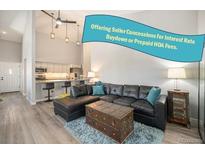 Inviting living room features a comfortable leather sectional sofa and stylish decor, perfect for relaxation at 2279 E 129Th Ave, Thornton, CO 80241