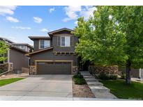 Charming two-story home features a three-car garage, stone accents, and well-maintained landscaping at 5301 Clovervale Cir, Highlands Ranch, CO 80130