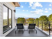 Relax on the private balcony with mountain views, perfect for outdoor seating and enjoyment at 9052 Harlan St, Westminster, CO 80031