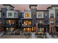 Modern townhome exterior with brick accents, balconies, and well-maintained landscaping at 9052 Harlan St, Westminster, CO 80031