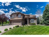 Beautiful two-story home featuring a well-manicured lawn and a three-car garage, perfect for Gathering living at 9315 E Aspen Hill Ln, Lone Tree, CO 80124