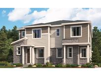 Beautiful two-story townhome featuring stone accents, neutral siding, and a well-manicured lawn at 24088 E Warm Springs Ave, Aurora, CO 80019