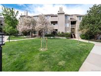 Apartment complex with well-maintained lawn and mature trees at 7408 S Alkire St # 301, Littleton, CO 80127