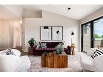 Bright living room featuring modern decor, stylish furniture, and access to a patio at 7408 S Alkire St # 301, Littleton, CO 80127