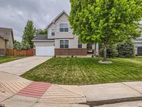 Charming two-story home with a well-manicured lawn and a welcoming front facade at 8010 Raspberry Dr, Frederick, CO 80504