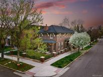 Beautiful brick home with a charming front yard, mature trees, and a picturesque view at 201 S Lafayette St, Denver, CO 80209