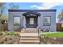 Charming gray brick home with a cozy covered entry and inviting front yard landscaping at 3130 N Race St, Denver, CO 80205