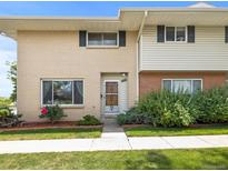 Charming two-story townhouse featuring a well-manicured lawn and attractive brick and siding facade at 3981 S Boston St, Denver, CO 80237
