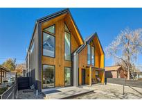 Striking modern home with unique architectural design, wood and metal accents, and large windows at 3829 Osage St, Denver, CO 80211