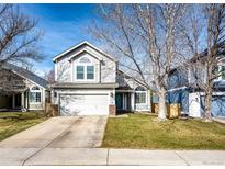 Charming two-story home featuring a two-car garage, well-maintained lawn, and inviting curb appeal at 11335 Haswell Dr, Parker, CO 80134