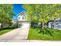 Charming home featuring a two car garage, lush lawn, mature trees, and delightful curb appeal at 11335 Haswell Dr, Parker, CO 80134