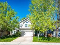 Charming two-story home with a well-manicured lawn and mature trees in a quiet neighborhood at 11335 Haswell Dr, Parker, CO 80134