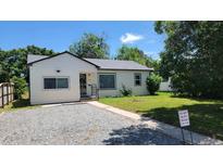 Charming single-story home with neutral siding, well-maintained lawn and updated landscaping at 1364 Iola St, Aurora, CO 80010