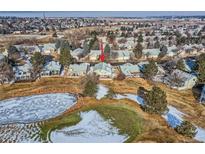 Stunning aerial view of home backing to golf course and pond in a mature neighborhood, perfect for serene living at 32 Canongate Ln, Highlands Ranch, CO 80130