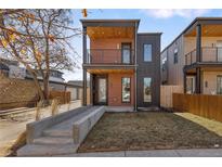 Modern home exterior featuring a balcony, a well-maintained lawn, and contemporary design at 2230 W 36Th Ave, Denver, CO 80211