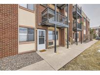 Brick exterior with metal balconies and access to unit, with a sidewalk leading to the entrance at 5995 W Hampden Ave # 8C, Denver, CO 80227