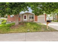 Charming single-Gathering home featuring a brick exterior, a well-manicured lawn, and mature trees for added curb appeal at 9054 Dover St, Westminster, CO 80021