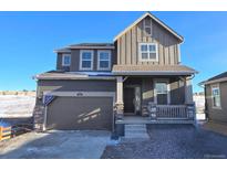 Two-story home with gray siding, stone accents, and a two-car garage at 250 Paloma Way, Elizabeth, CO 80107