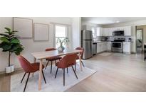 Bright dining area with a wooden table, seating for four, and modern art accents, adjacent to the kitchen at 4325 S Cherokee St, Englewood, CO 80110