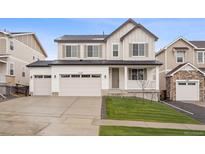 Charming two-story home with a three-car garage and well-manicured front lawn at 5549 Riverbend Ave, Firestone, CO 80504