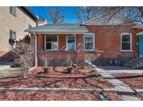 Charming brick home with a cozy front porch and well-maintained landscaping at 288 S Sherman St, Denver, CO 80209