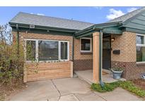 Charming brick home featuring a welcoming front entrance, flower box and freshly landscaped accents at 3075 N Elm Ave, Denver, CO 80207