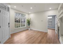 Bright living room features wood floors, a large window, and an open floor plan at 9590 E Florida Ave # 1025, Denver, CO 80247