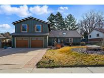 Charming two-story home featuring a well-manicured lawn and a two-car garage, located in a desirable neighborhood at 4468 S Zenobia St, Denver, CO 80236