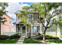 Charming two-story home with a well-maintained lawn, sidewalk, and lush landscaping at 1655 S Buckley Cir, Aurora, CO 80017