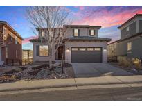 Stunning two-story home featuring a covered entryway, manicured yard, and a two-car garage at 10659 Montecito Dr, Lone Tree, CO 80124