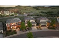 Three attractive homes feature manicured front yards, paired garages, and an idyllic hilltop community at 10659 Montecito Dr, Lone Tree, CO 80124