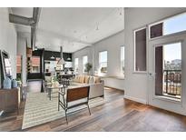 Bright and airy living room with hardwood floors and a view of the city at 2501 15Th St # 3F, Denver, CO 80211