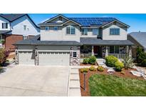 Beautiful two-story home with a three car garage, solar panels and manicured front yard at 22227 E Hinsdale Ave, Aurora, CO 80016