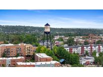 A captivating view of the city featuring the iconic water tower, complemented by lush greenery and charming buildings at 7828 W 54Th Ave, Arvada, CO 80002